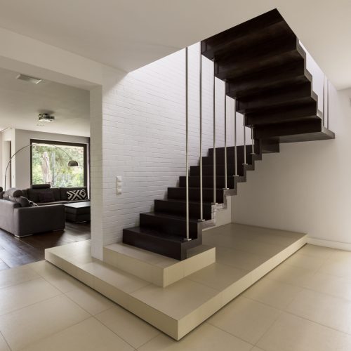 Staircase in the corridor with living room in the background